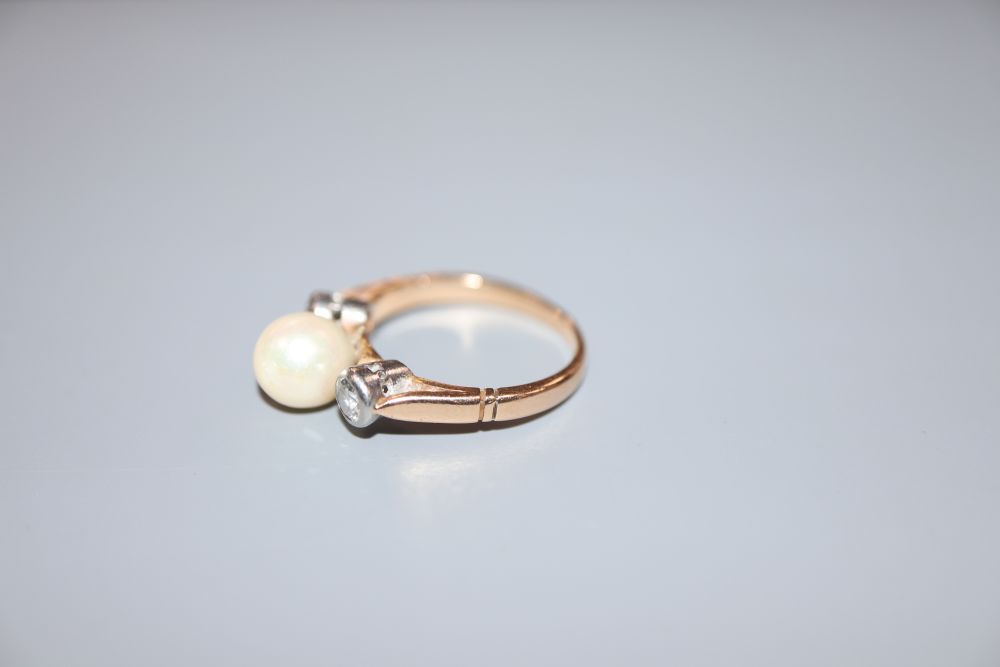 A yellow metal, single cultured pearl and two stone diamond ring, size K/L, gross 3.9 grams.